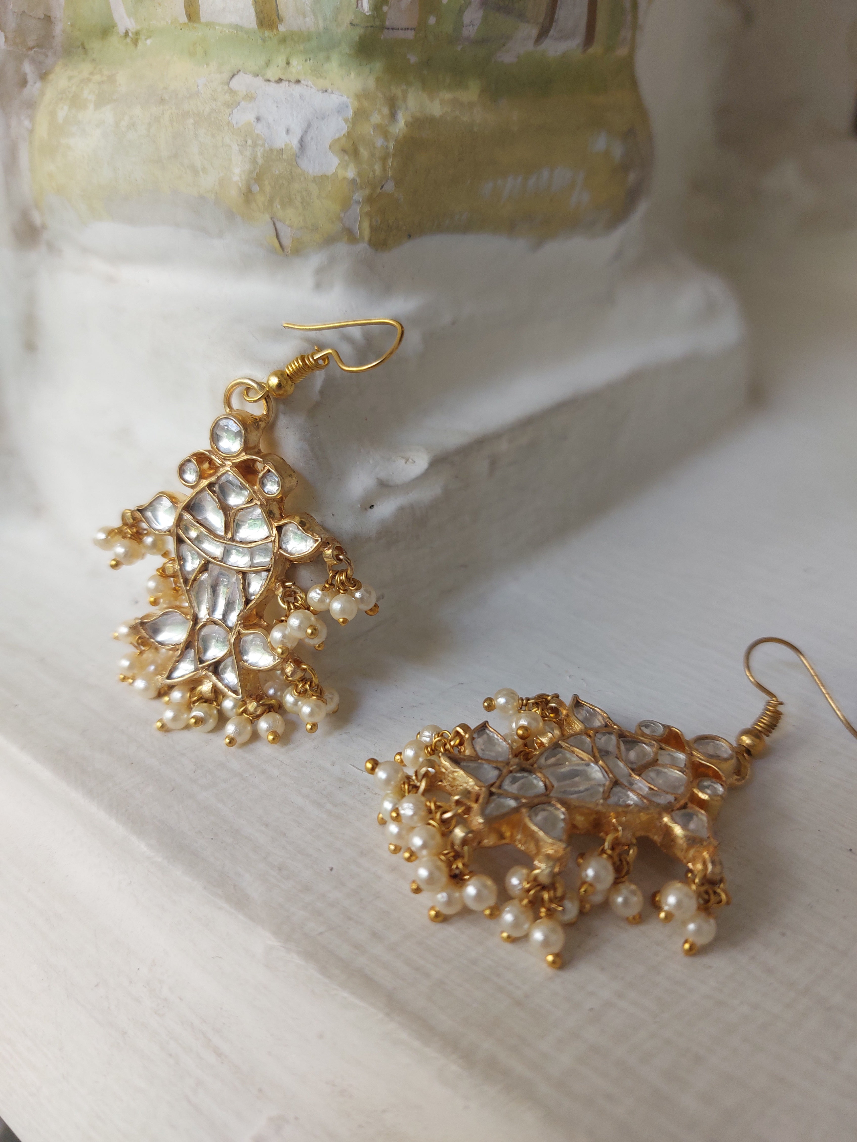 Gold plated kundan fish earrings close-up detail