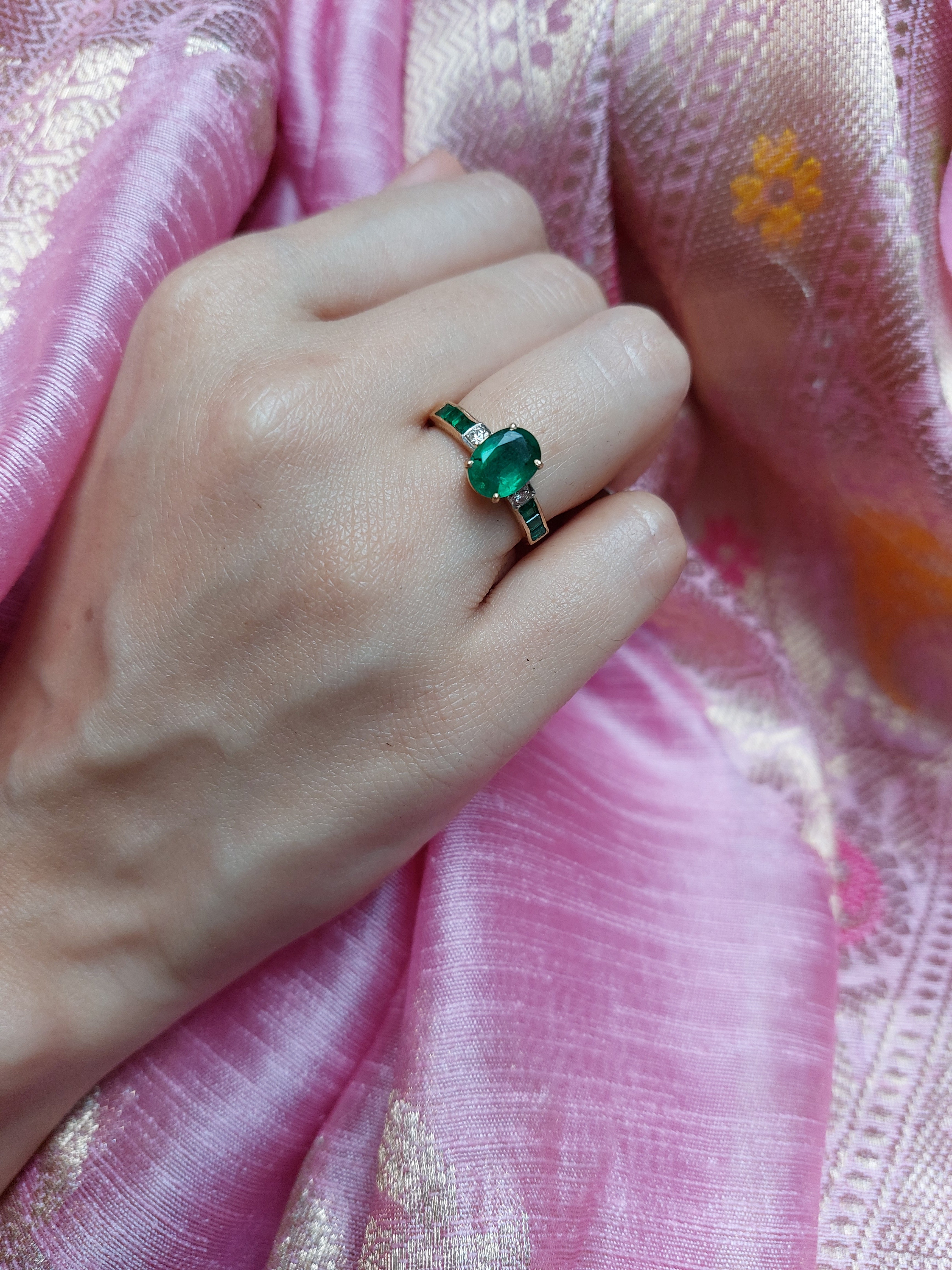 14K gold emerald-cut ring worn on hand