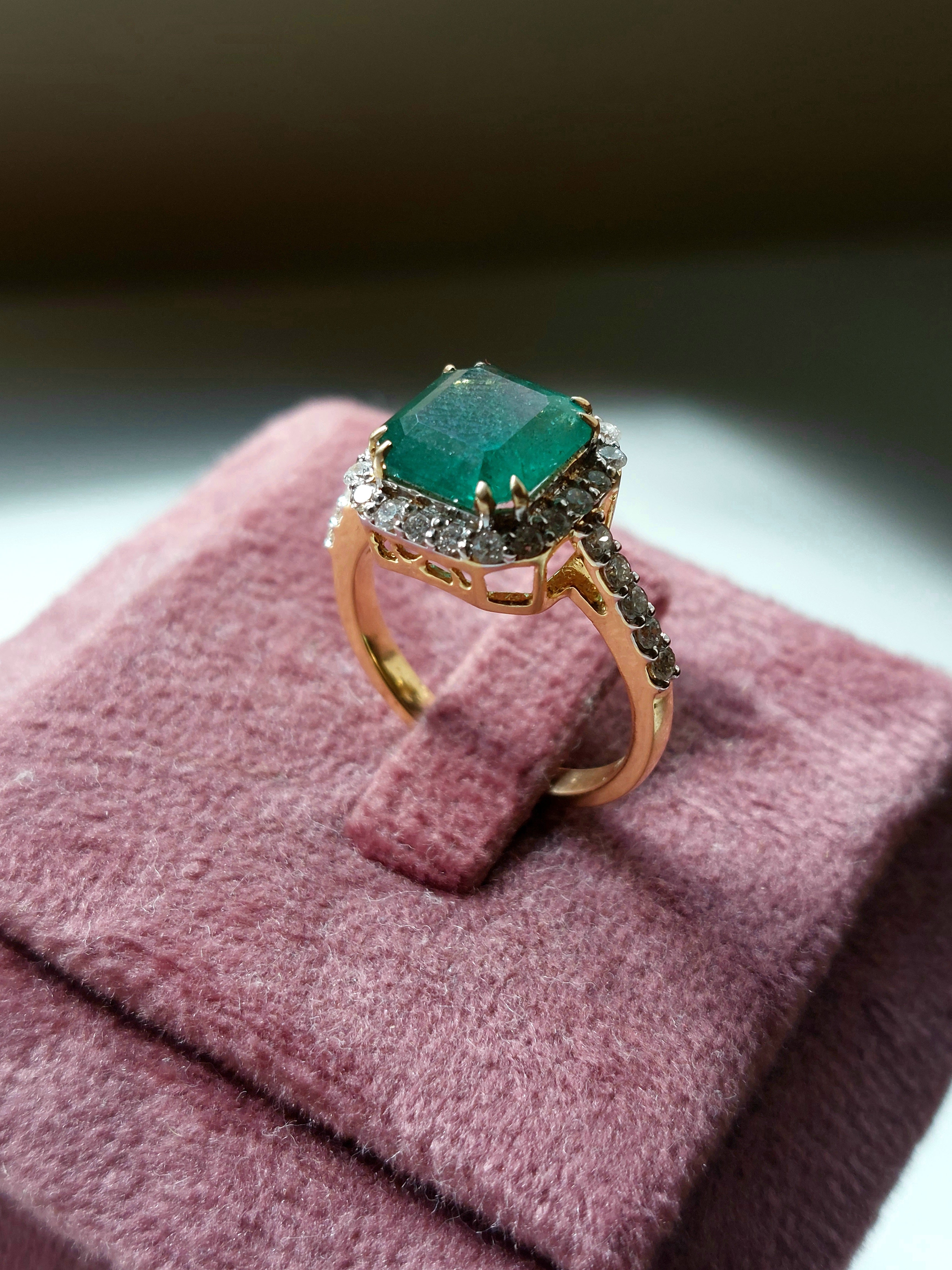 14K gold square emerald ring on velvet display stand