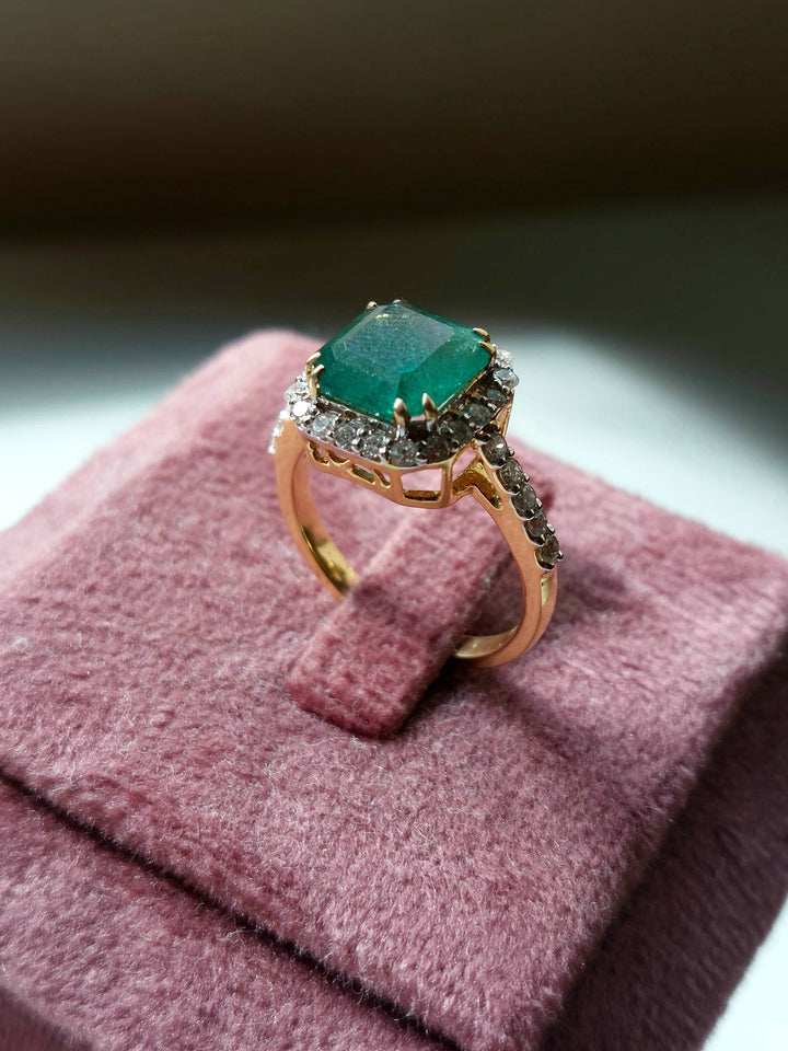 14K gold square emerald ring on velvet display stand