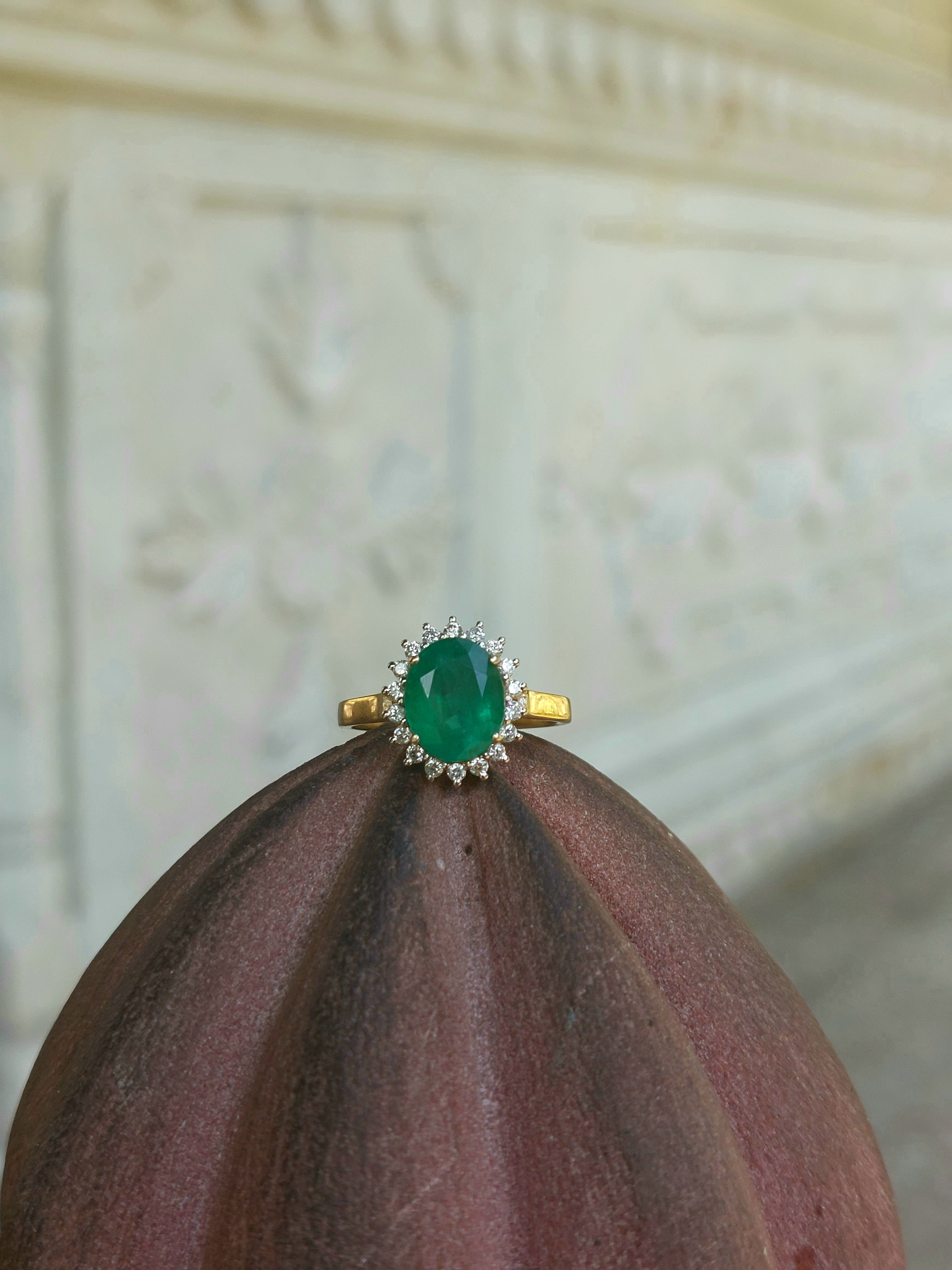 14K gold Nusrat Ring with emerald center stone and diamonds