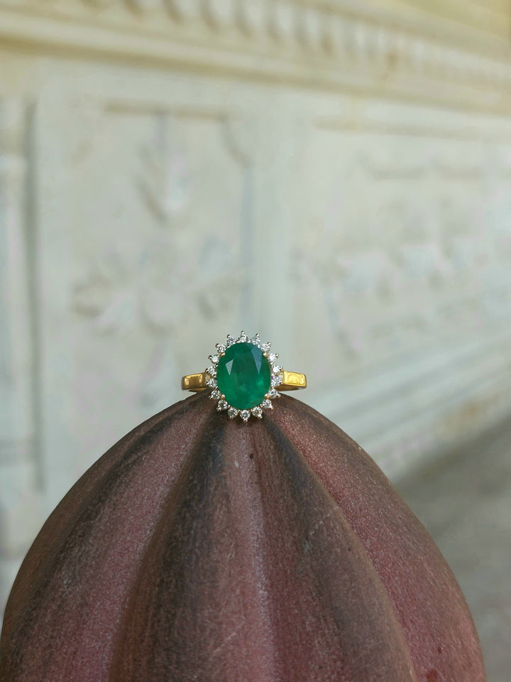 14K gold Nusrat Ring with emerald center stone and diamonds