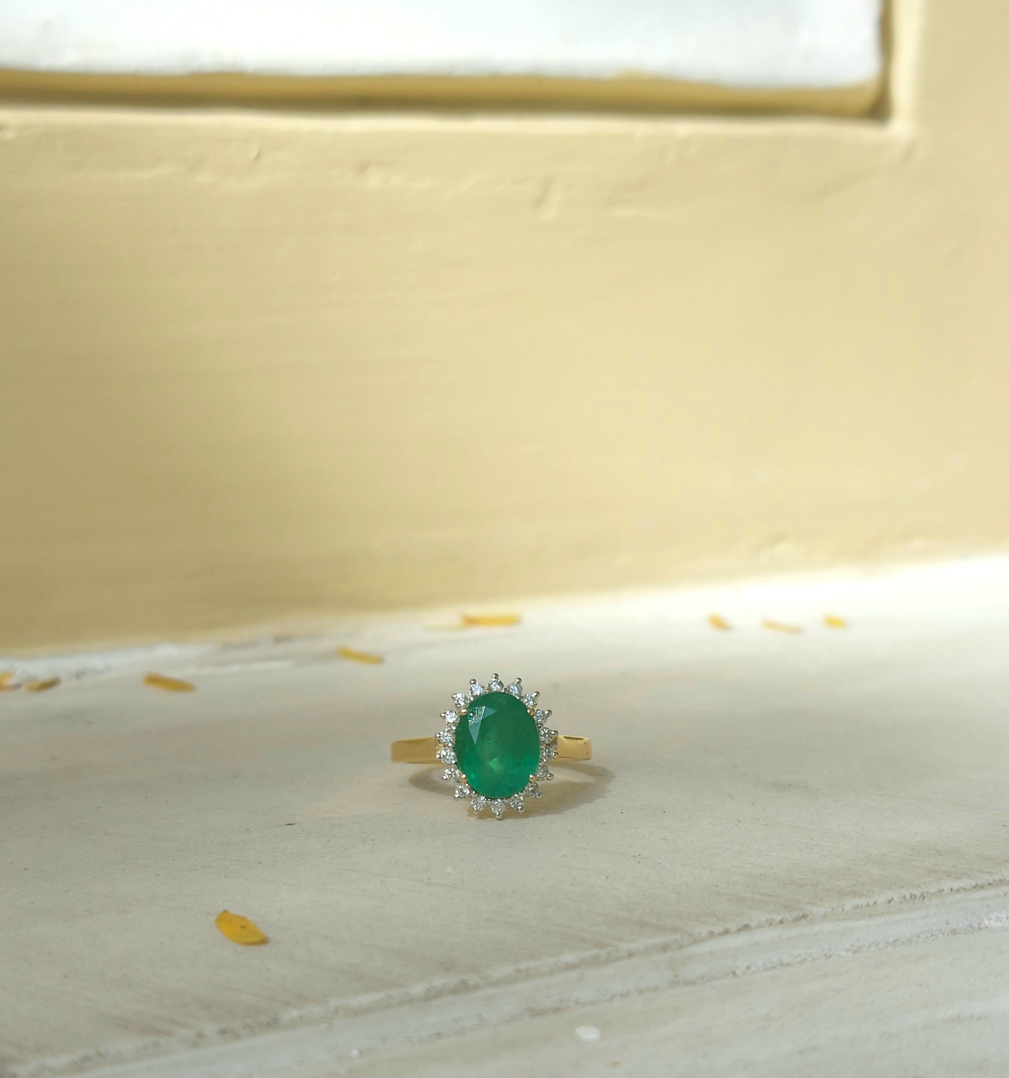 14K gold emerald ring with white accent stones