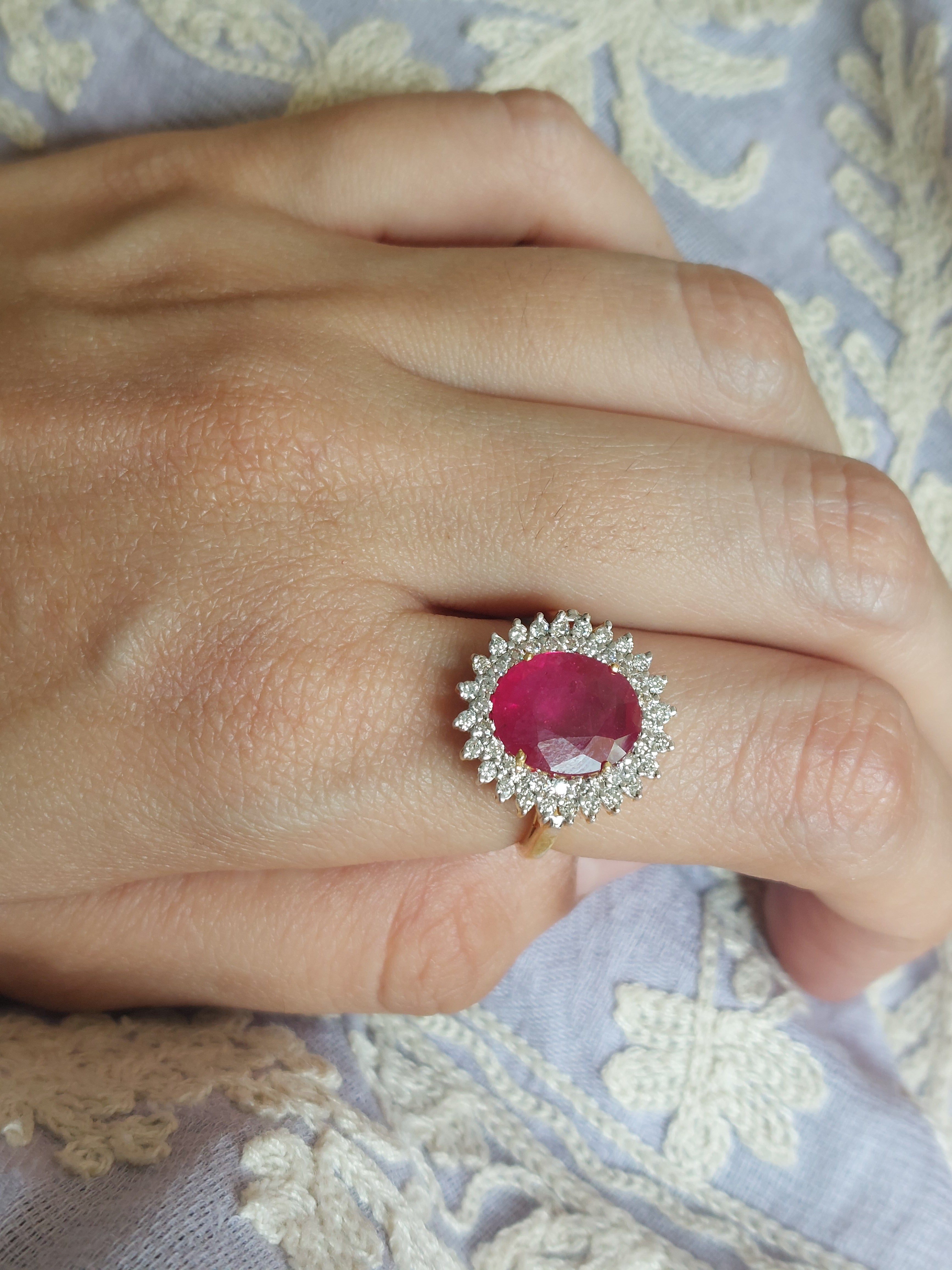 14K gold ruby ring with oval gemstone and clear accent stones