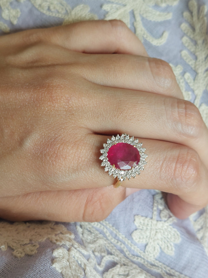 14K gold ruby ring with oval gemstone and clear accent stones