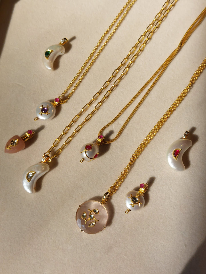 Gold pearl ruby diamond pendant close-up