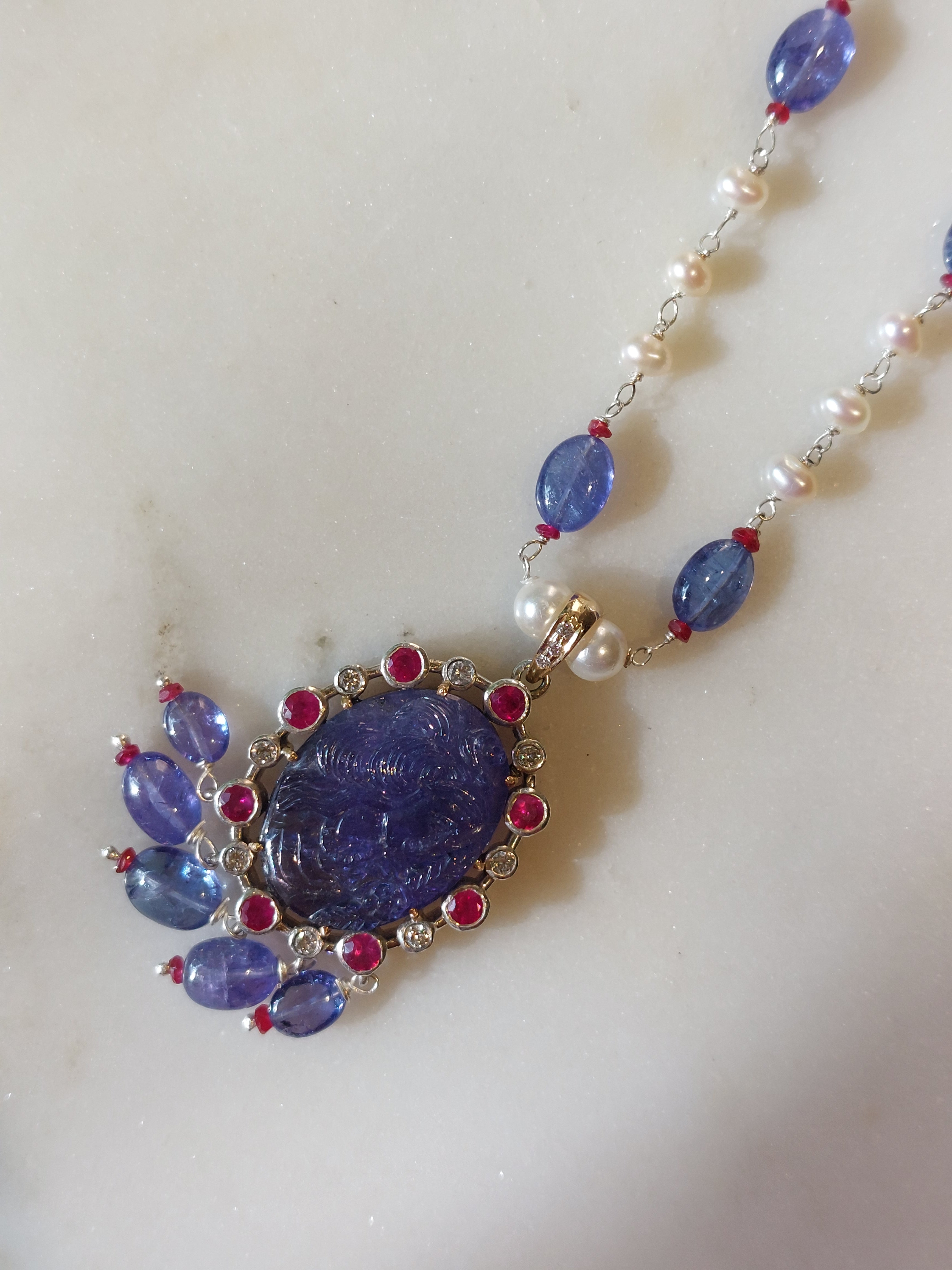 Gold tanzanite ruby pendant mala close-up detail