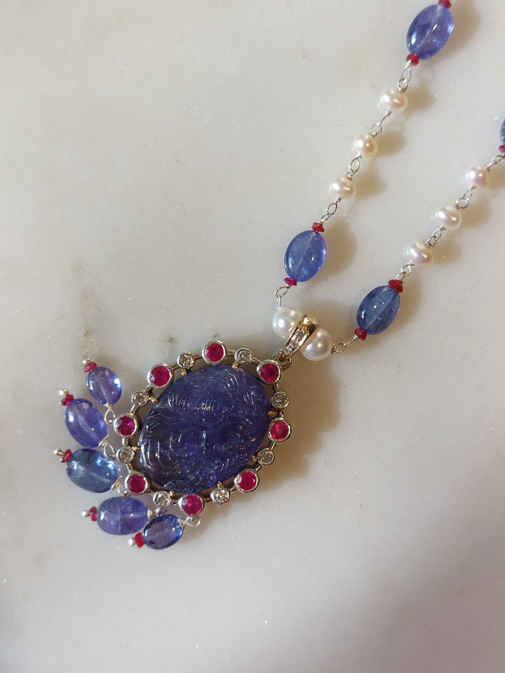 Gold tanzanite ruby pendant mala close-up detail
