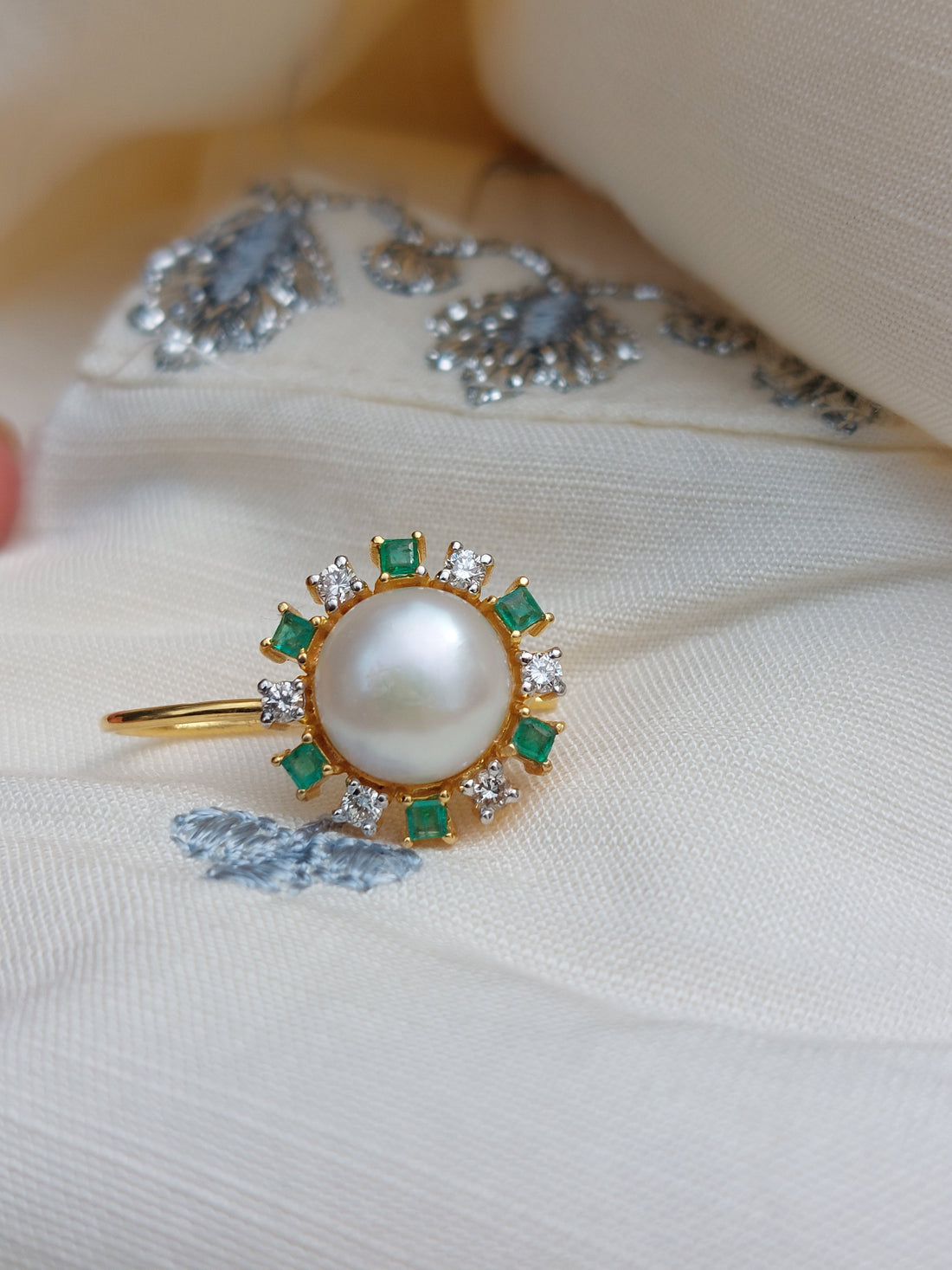 14K gold emerald pearl drop earrings close-up angle