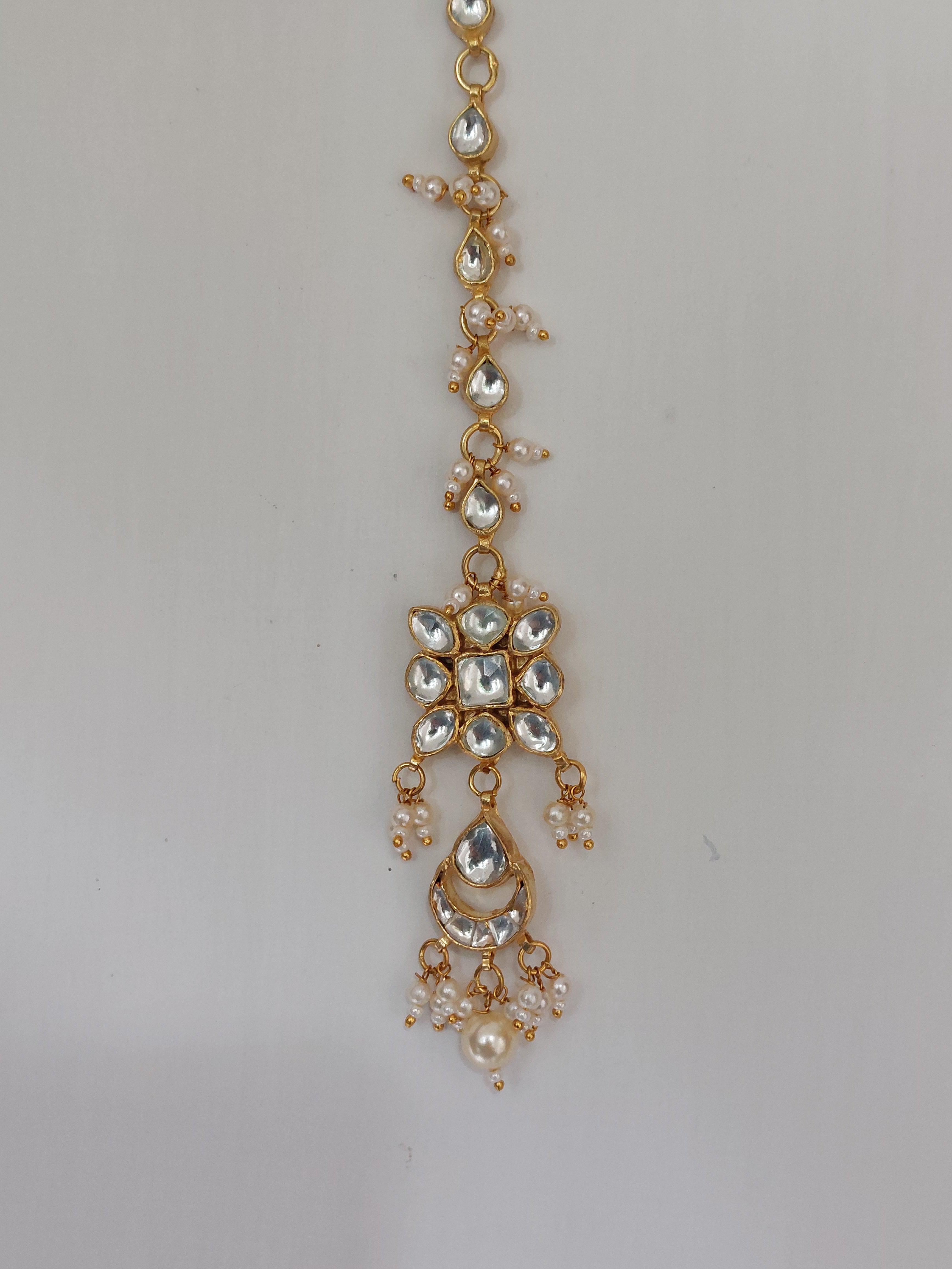 Silver alloy kundan tika close-up detail