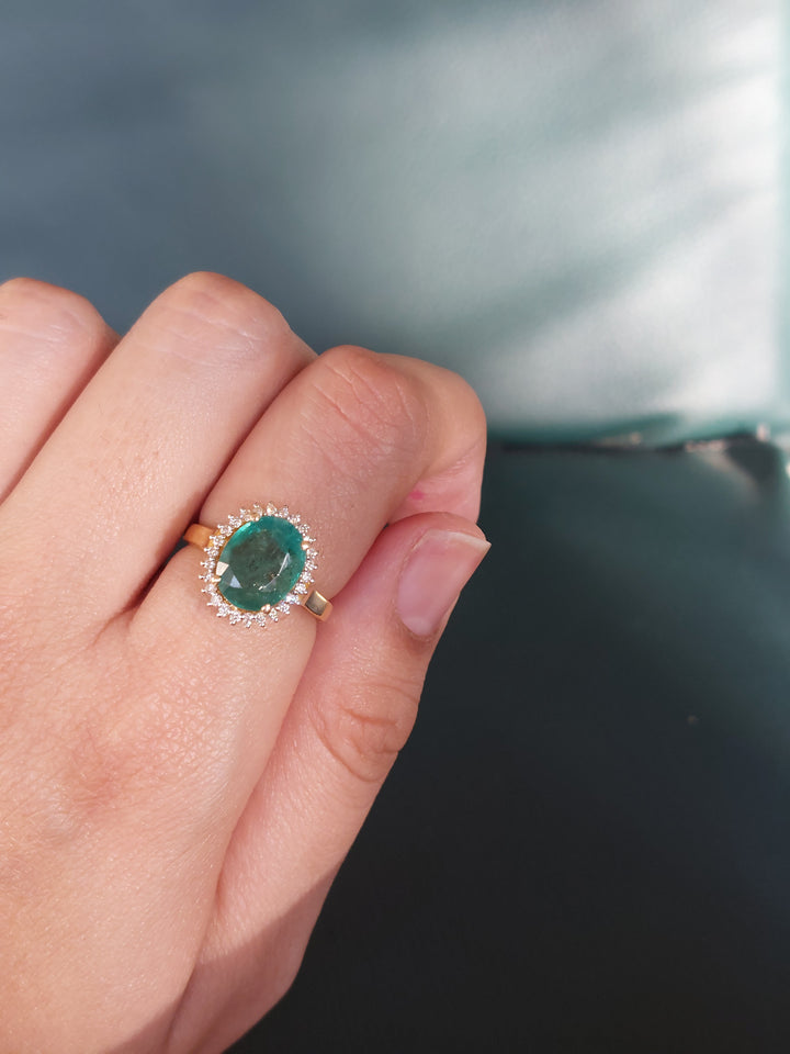 Oval emerald and diamond halo ring product photo