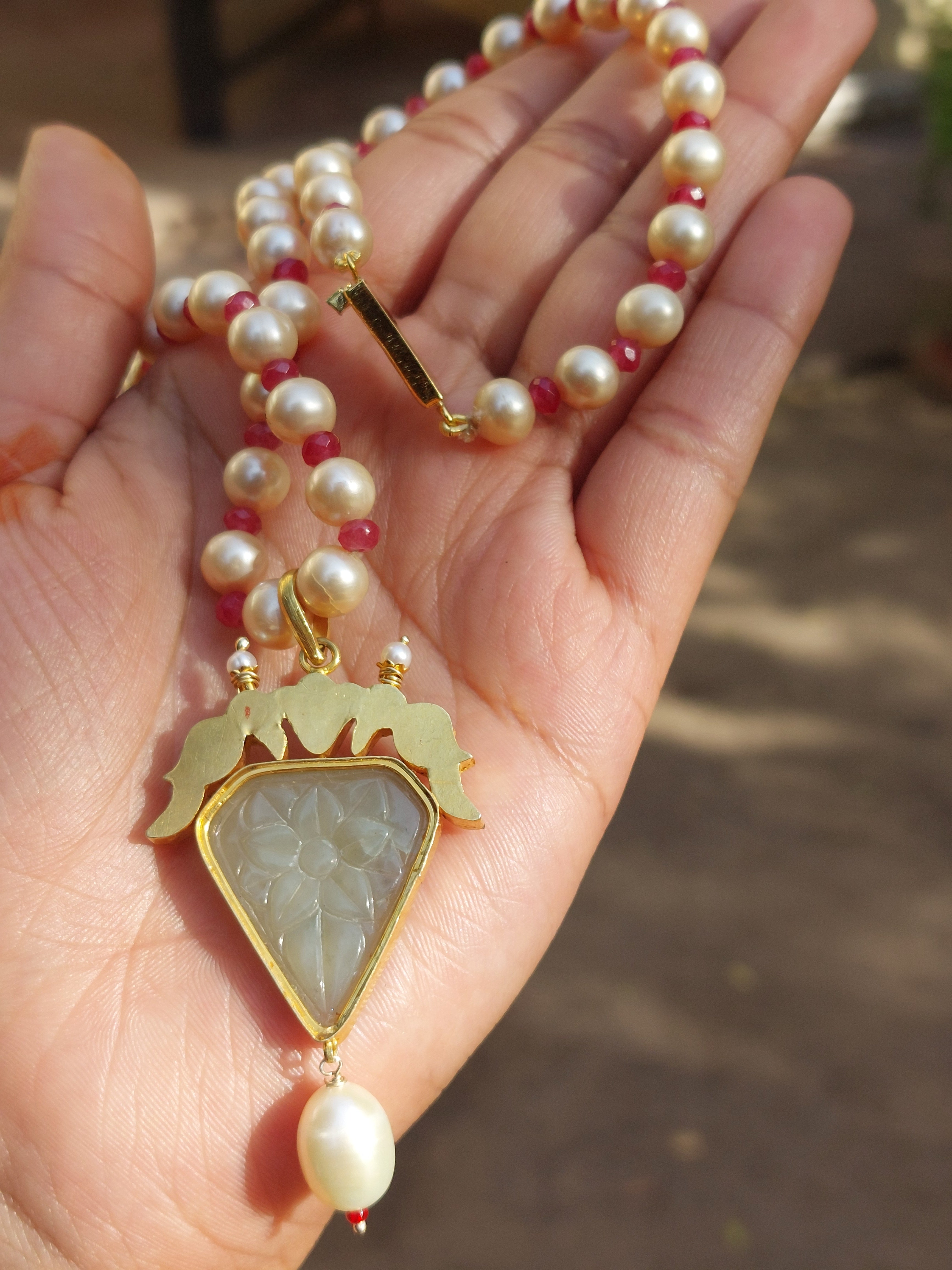 Gold ruby pearl polki pendant necklace close-up
