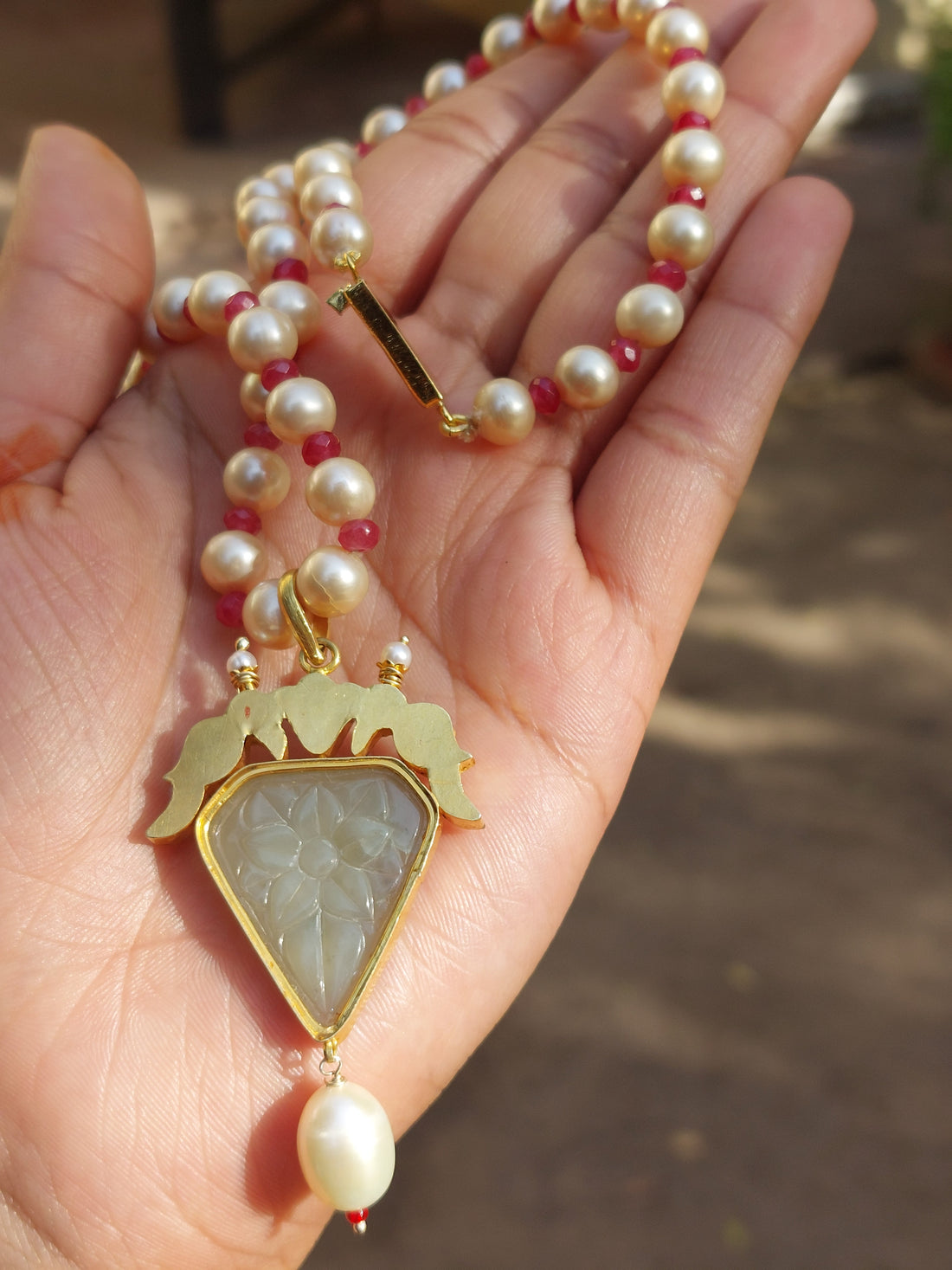Gold ruby pearl polki pendant necklace close-up