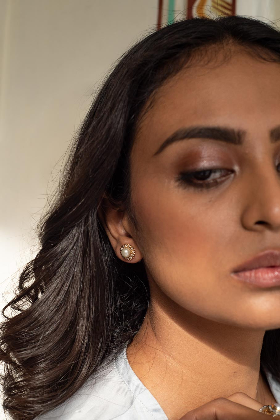 14K gold pearl stud earring worn on ear