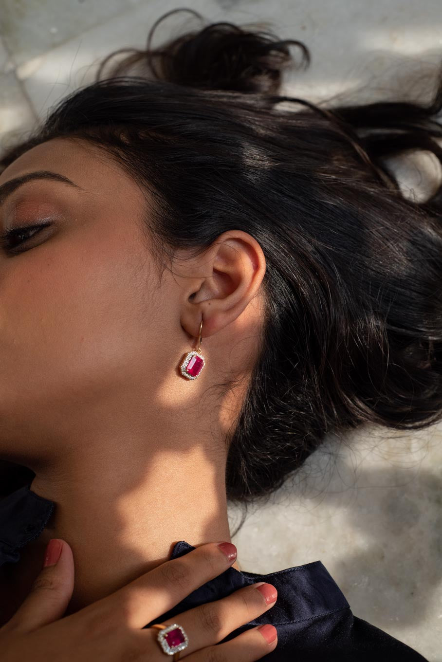 14K gold ruby earrings with diamond halo worn by model