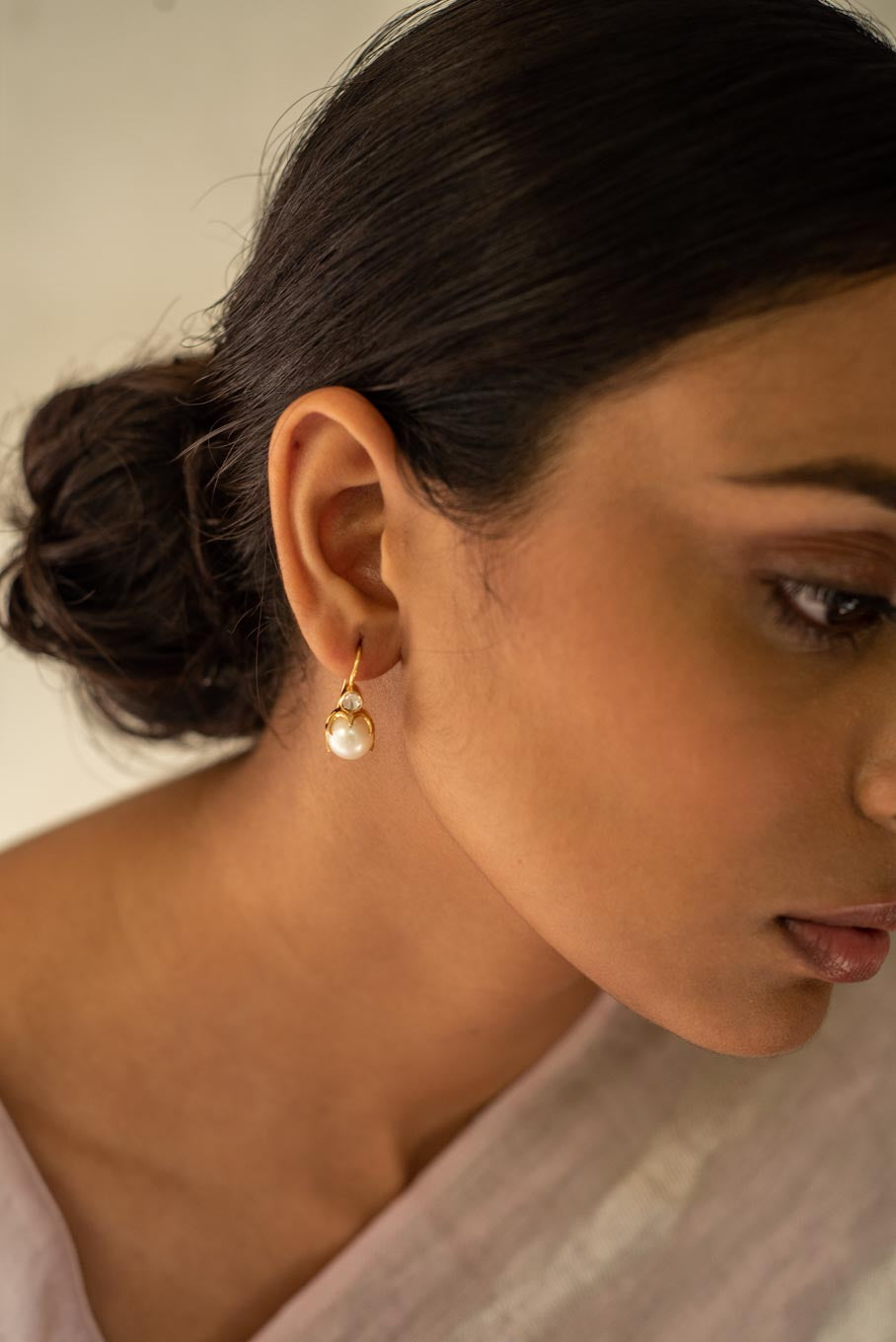 14K gold polki earring with pearl drop worn on woman
