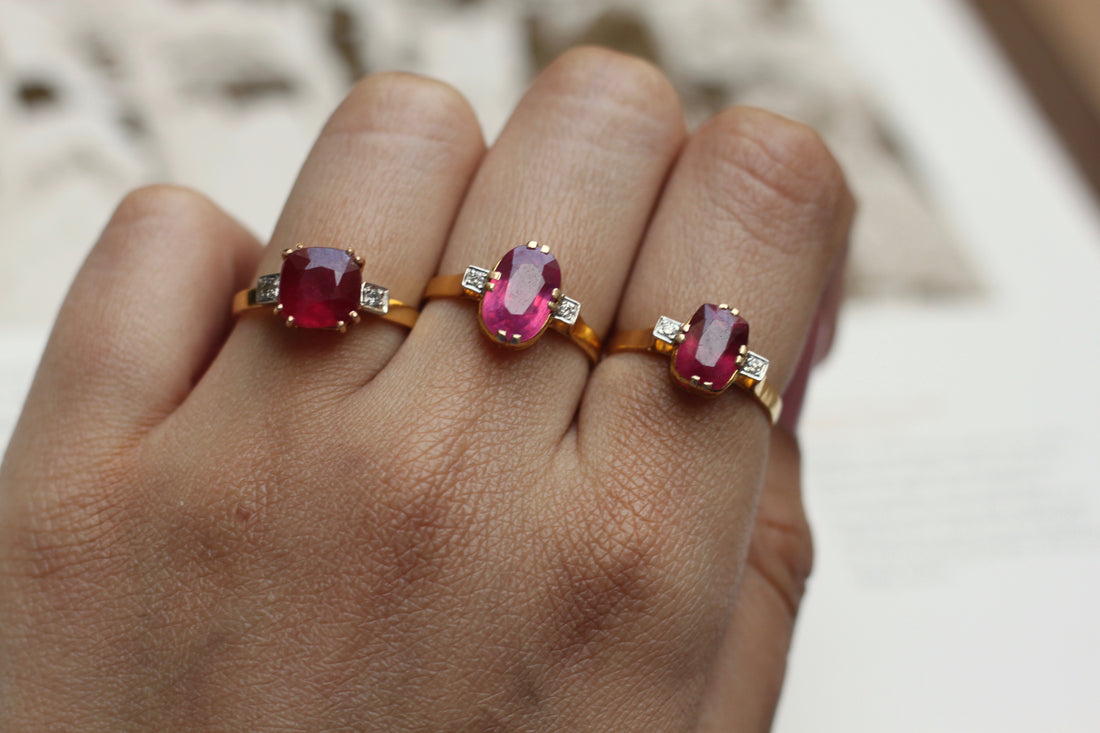 14K gold ruby and diamond rings with oval gemstones on fingers