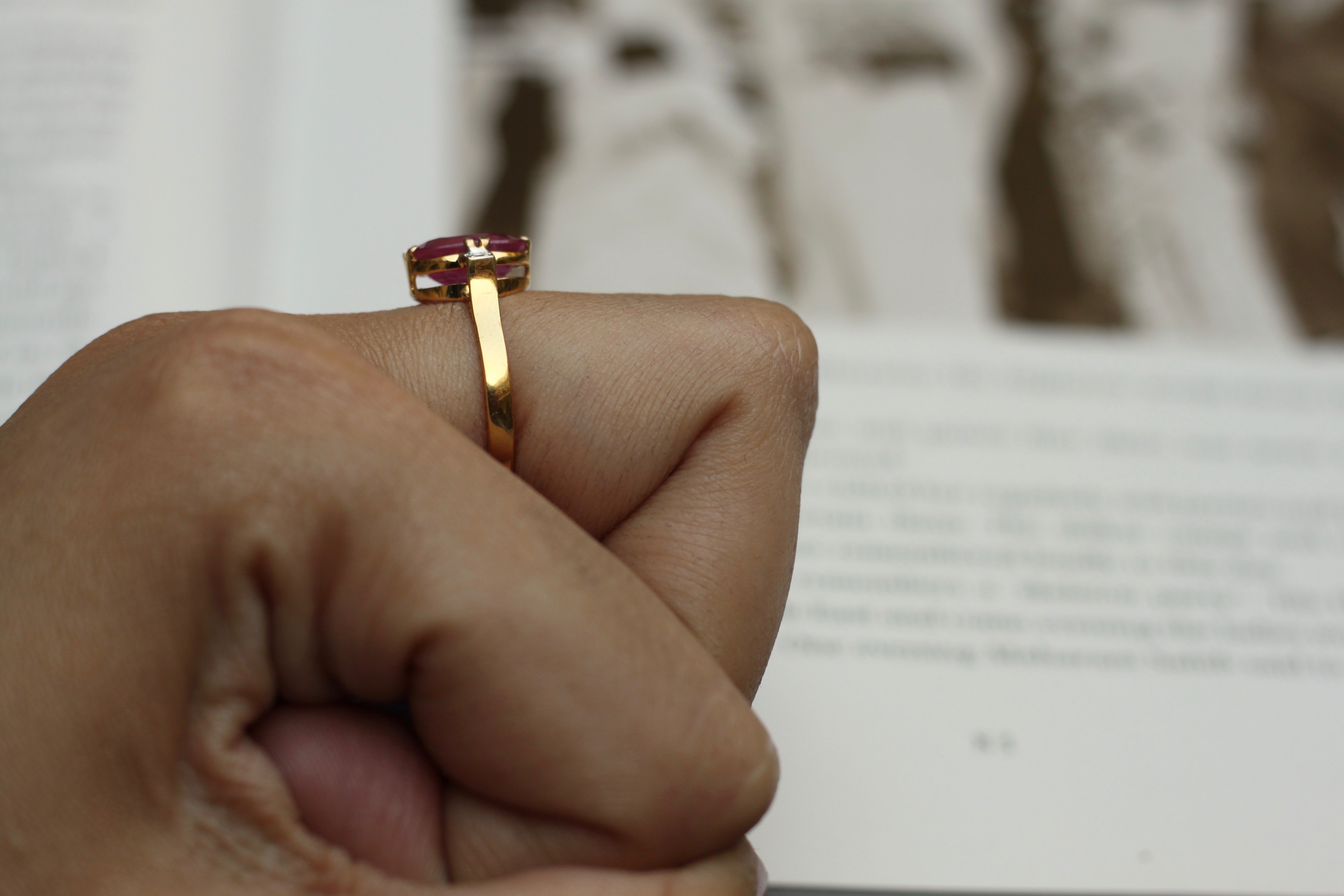 14K gold ruby band ring with round pink gemstone on fist