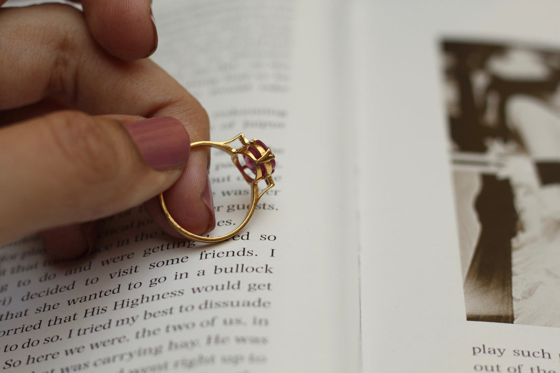 14K gold Naila Ring floral design held over open book