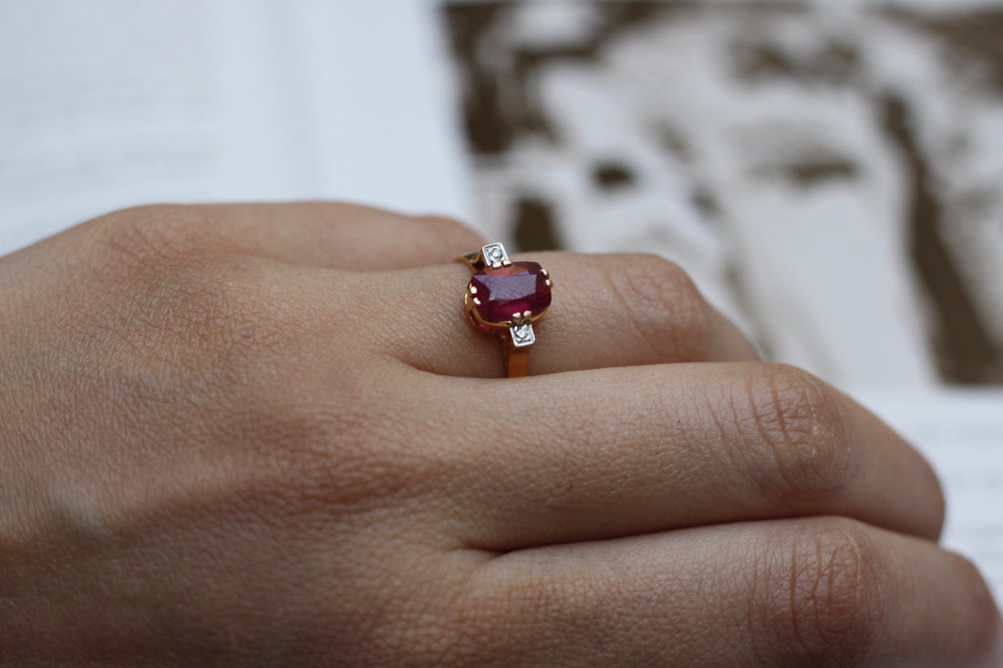 14K gold rectangular ruby ring with round diamonds on hand