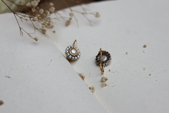 14K gold pearl diamond drop earrings on white background
