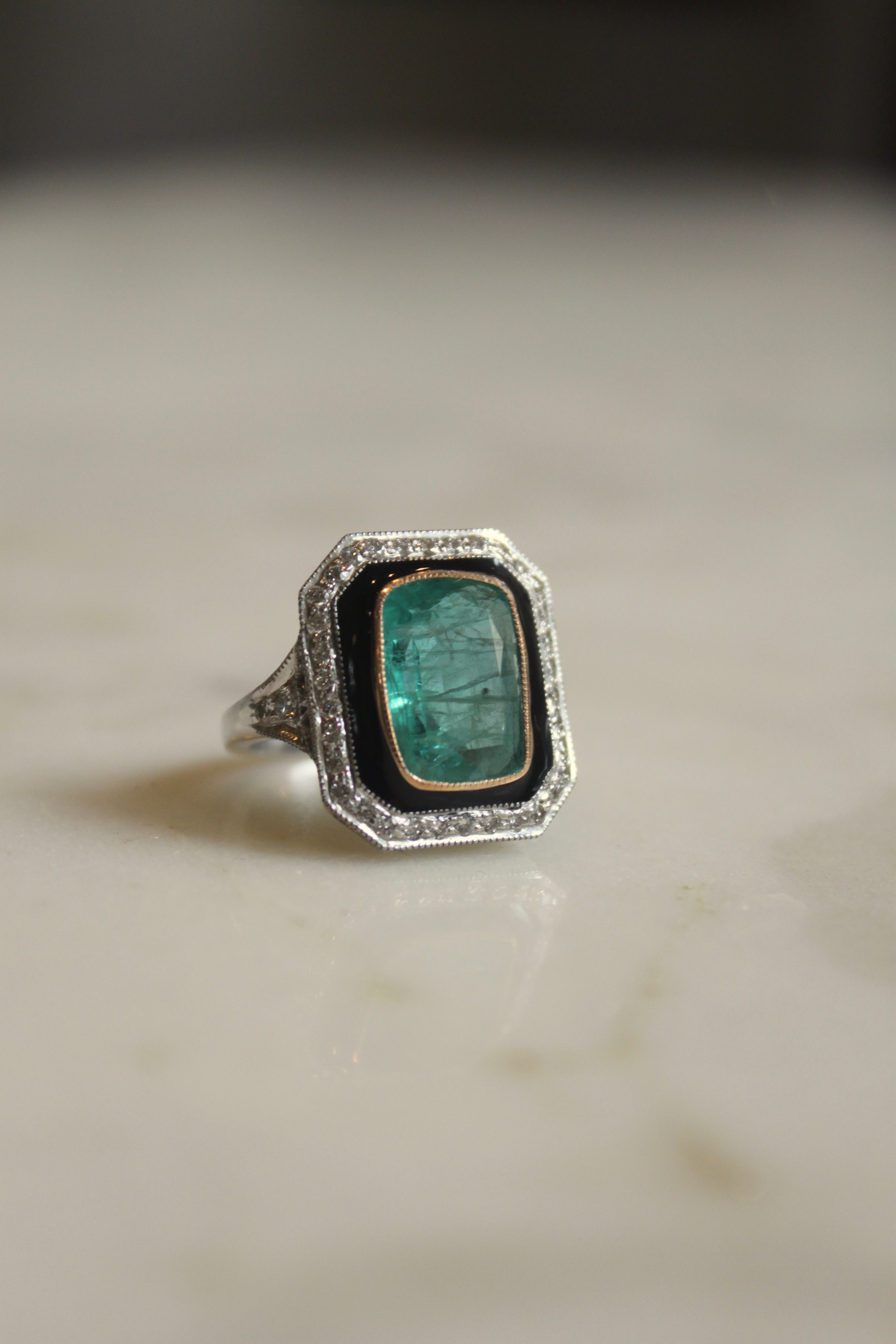 Art Deco emerald ring curved band detailing