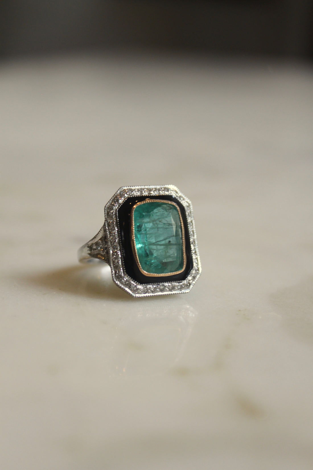 Art Deco emerald ring curved band detailing