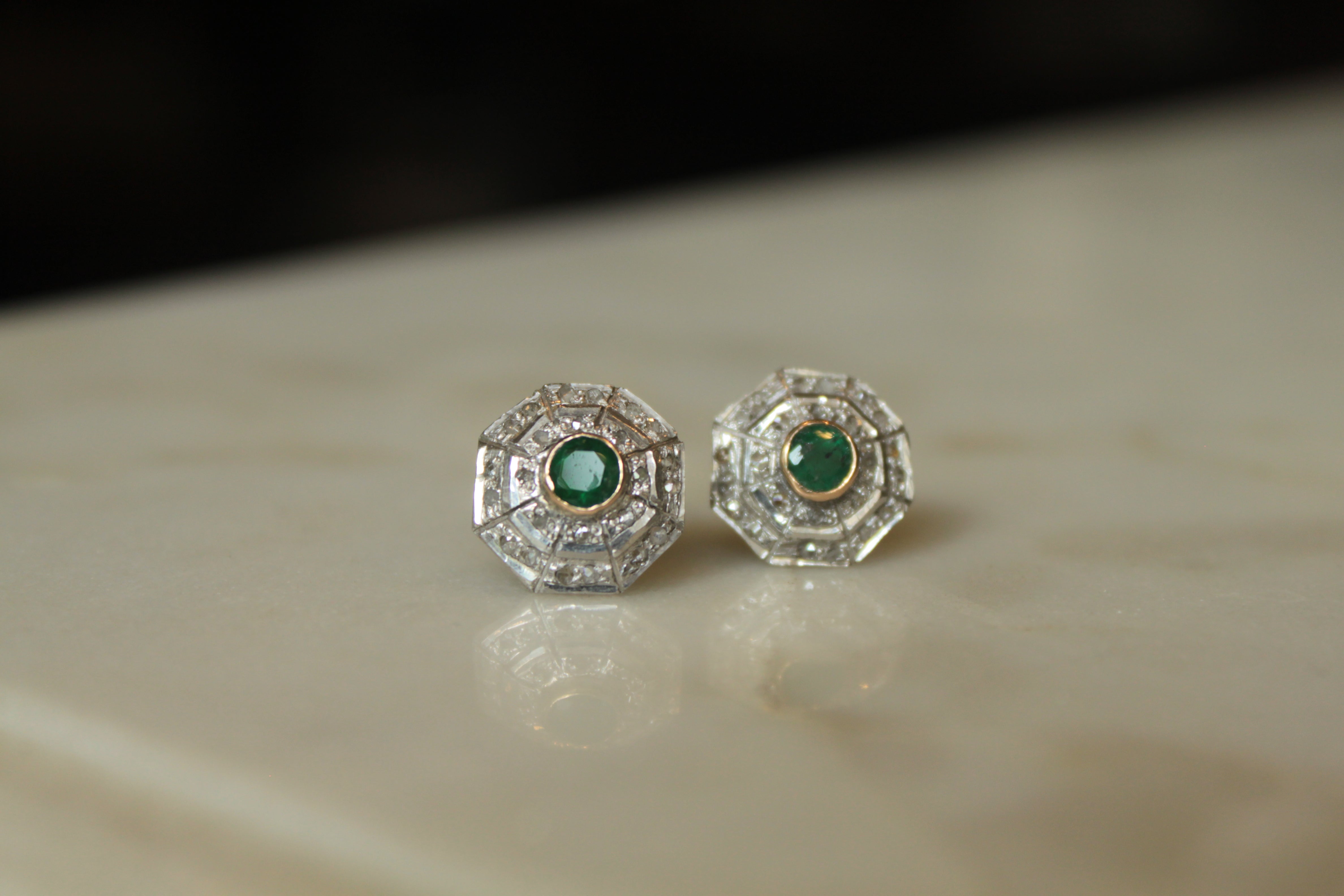 Art Deco earrings round emerald centers geometric detailing