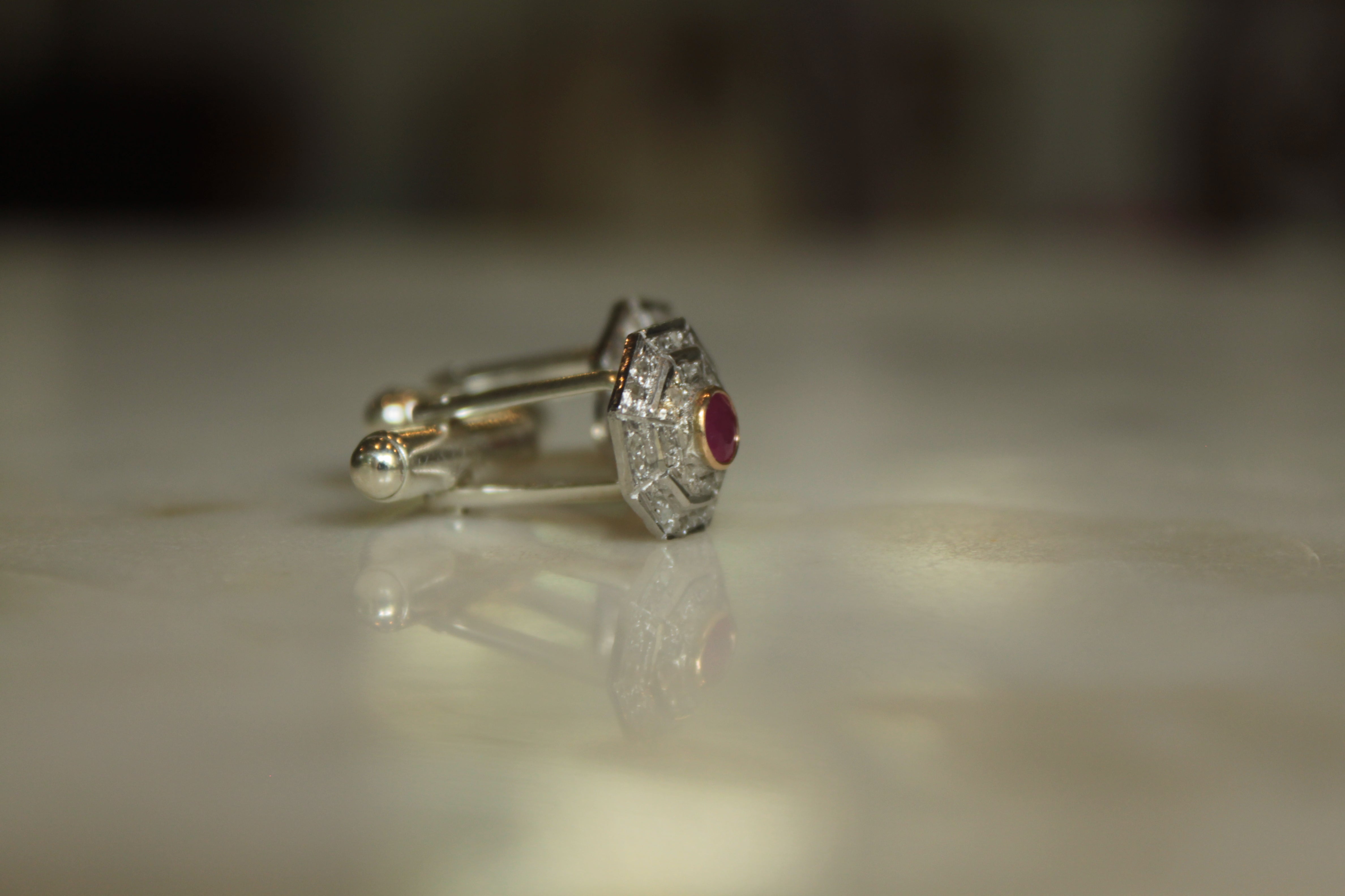 925 silver Art Deco ruby cufflinks on reflective surface