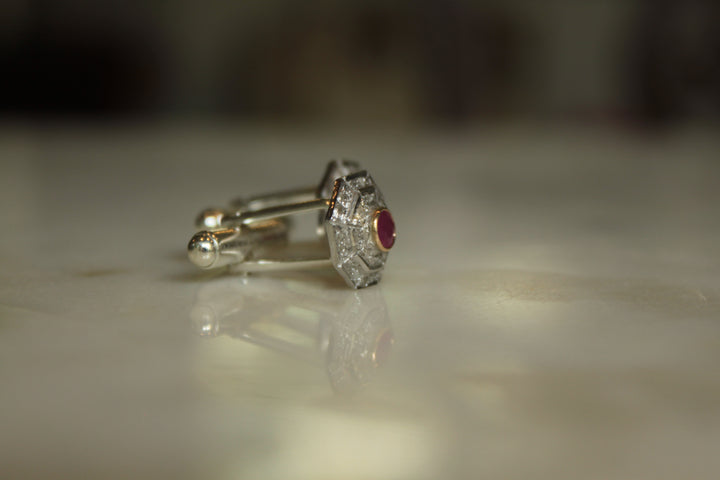 925 silver Art Deco ruby cufflinks on reflective surface