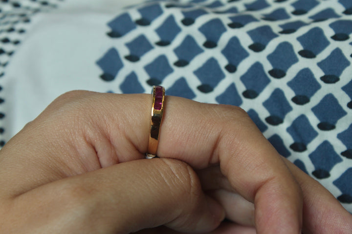 14K gold ruby half band ring worn on finger