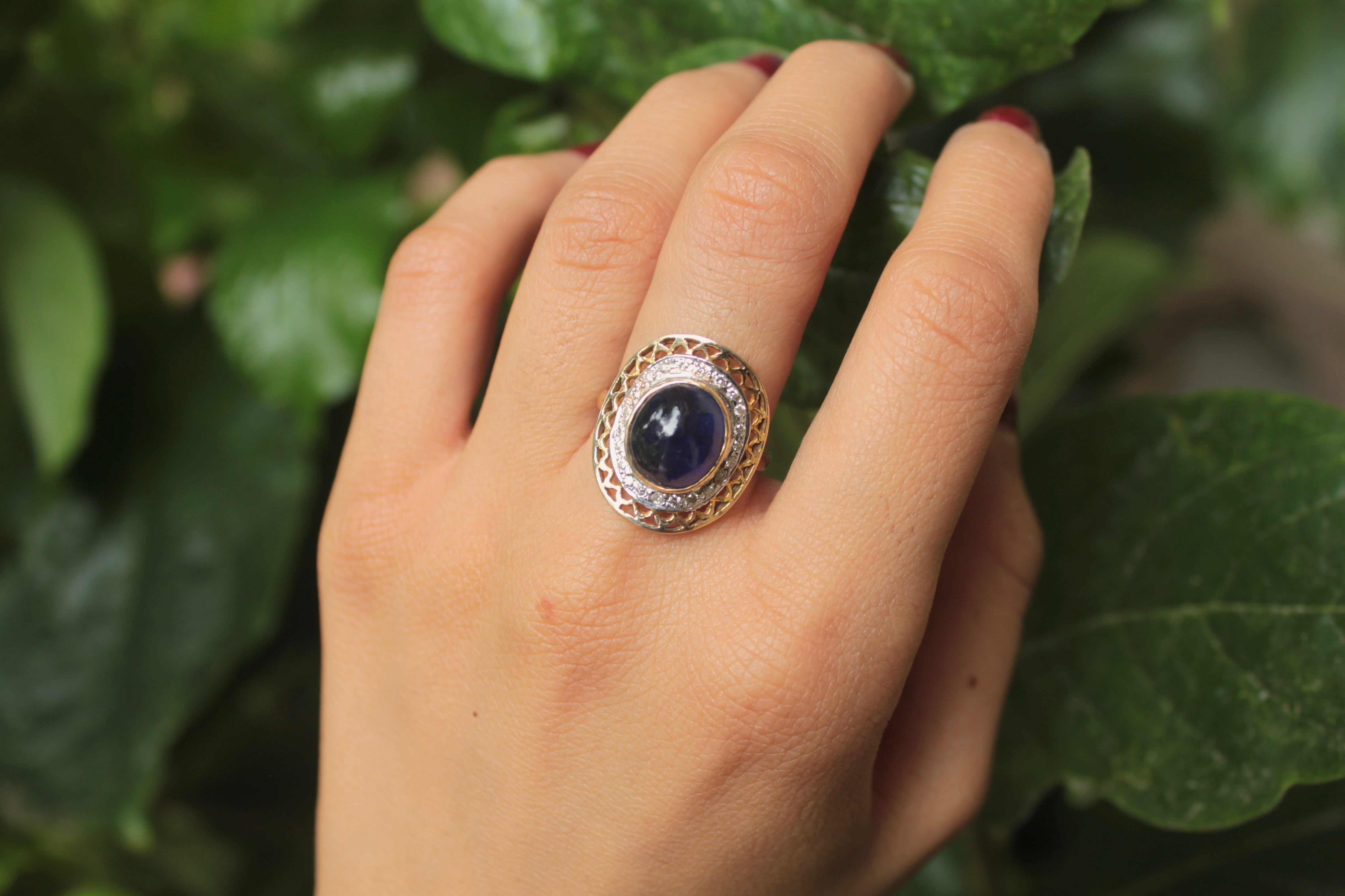 14K gold large oval sapphire ring surrounded by diamonds