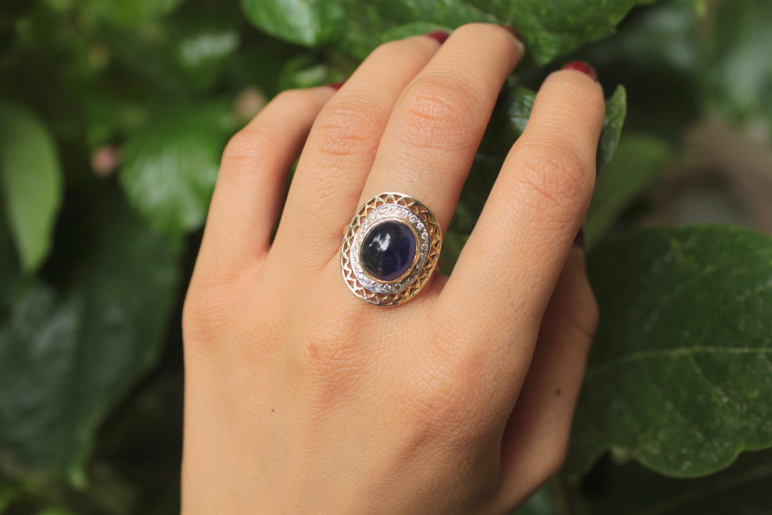 14K gold large oval sapphire ring surrounded by diamonds