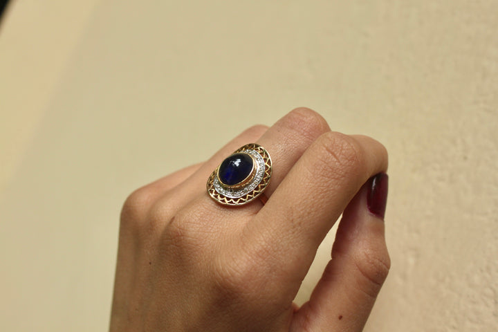 14K gold oval sapphire ring with diamond halo design